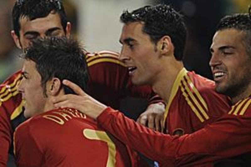 Spain players congratulate David Villa, No 7, after the striker scores the first goal in Spain's 2-0 win over the Confederations Cup hosts South Africa.