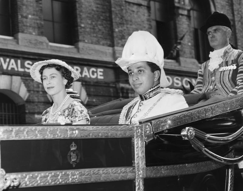 King Faisal II of Iraq and Queen Elizabeth II leave Victoria Station in London for Buckingham Palace on July 16, 1956. Getty