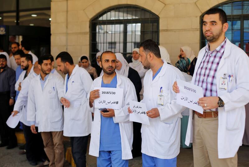 Doctors involved in the strike stand outside their hospital. Muhammad Hamed / Reuters