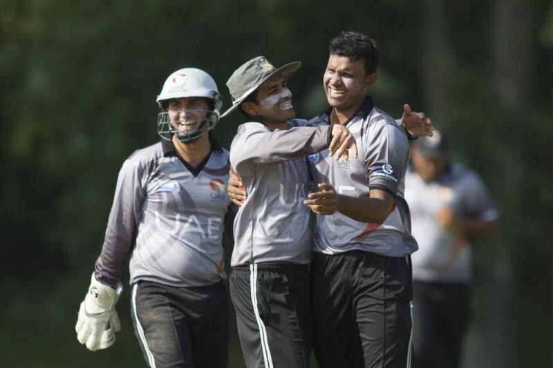 Khurram Khan, centre, is confident his bowlers can cause trouble for Hong Kong’s rusty middle-order batsmen on Thursday. Chris Young / The National