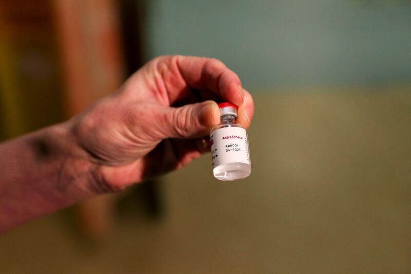 Chief nurse nurse Sam Foster holds a vial of the Oxford University/AstraZeneca vaccine, at the Churchill Hospital in Oxford. AP Photo