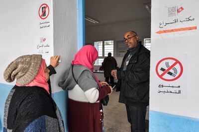 Voters queue outside a polling station during the 2023 local elections on the outskirts of Tunis. AFP