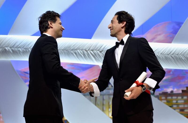 Director Bennett Miller, winner of the Best Director Prize for his film Foxcatcher, poses with actor Adrien Brody. Pascal Le Segretain / Getty Images
