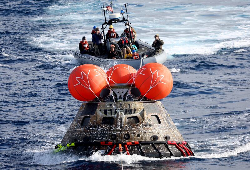 AT SEA, PACIFIC OCEAN - DECEMBER 11: NASA's Orion Capsule is drawn to the well deck of the U. S. S.  Portland after it splashed down following a successful uncrewed Artemis I Moon Mission on December 11, 2022 seen from aboard the U. S. S.  Portland in the Pacific Ocean off the coast of Baja California, Mexico.  A 26-day mission took the Orion spacecraft to the moon and back which completed a historic test flight that coincided with the 50th anniversary of the landing of Apollo 17 on the moon, the last time that NASA astronauts walked there.  Mario Tama / Pool via REUTERS     TPX IMAGES OF THE DAY