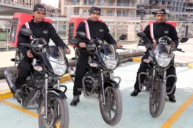 Ranil Suresh, Sajjad Ahmad and Diadarul Haque, delivery riders for Freedom Pizza, at Dubai Marina. Pawan Singh / The National 