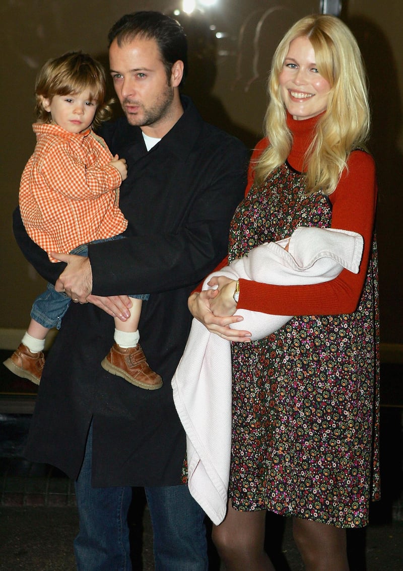 LONDON - NOVEMBER 17: Former supermodel Claudia Schiffer (R) poses for photographers with her new daughter Clementine as husband Matthew Vaughn and son Caspar look on at Portland Hospital on November 17, 2004 in London, England. German catwalk queen Claudia Schiffer gave birth to a baby daughter at the Portland Hospital on November 11, 2004 in London, England. (Photo by Scott Barbour/Getty Images)