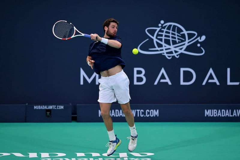 Cameron Norrie hits a forehand to Stefanos Tsitsipas. AFP