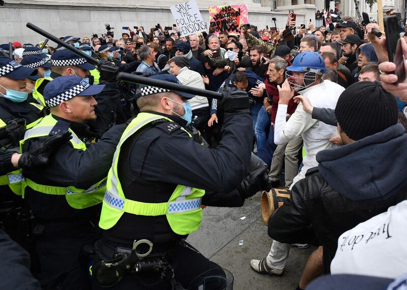 Police move in to disperse protesters in Trafalgar Square.  AFP