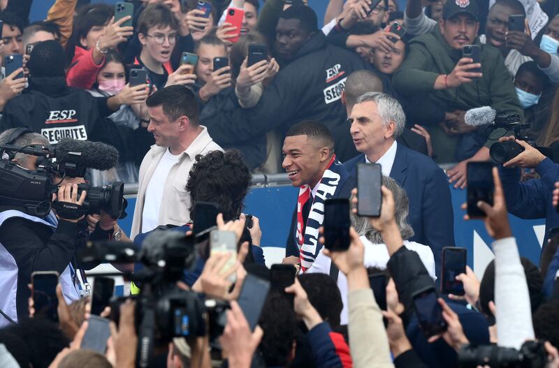 Kylian Mbappe is cheered by supporters outside the Parc des Princes after announcing his new contract. AFP