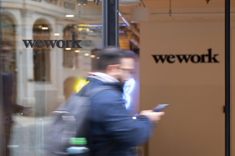 A pedestrian walks past the entrance to the We Work co-working office space, operated by the parent company We Co., on Eastcheap in London, U.K., on Monday, Oct. 7, 2019. While WeWork has been rapidly expanding in Canada, the New York-based company is facing challenges on multiple fronts with Landlords in London and New York the most exposed to any further deterioration at the co-working firm. Photographer: Bryn Colton/Bloomberg