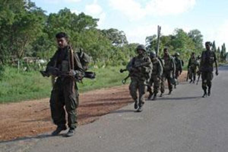 In this handout picture releasesd by the Sri Lankan Defence Ministry on January 3, 2009, is said to show government troops entering the Tamil Tiger political capital town of Kilinochchi, some 330 kilometers (202 miles) north of Colombo.  Sri Lankan troops advanced on the military headquarters of the Tamil Tigers, a day after capturing the rebels' de facto political capital in the north of the island. The defence ministry said forces were moving towards Mullaitivu, the jungle district along the northeastern seaboard, where the Tigers are known to have their main military facilities.   AFP PHOTO/HO/DEFENCE MINISTRY    RESTRICTED TO EDITORIAL USE    GETTY OUT *** Local Caption ***  006937-01-08.jpg