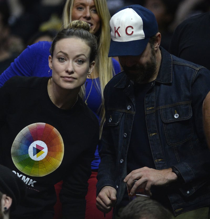 Olivia Wilde, in a colour wheel sweater, and Jason Sudeikis attend the Los Angeles Clippers-Orlando Magic NBA game at the Staples Centre in Los Angeles, California, on December 5, 2015.
