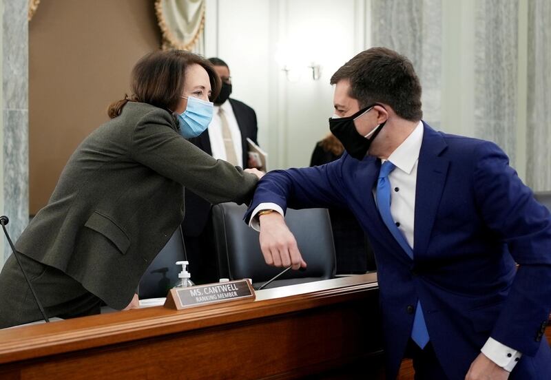FILE PHOTO: U.S. Senator Maria Cantwell and Peter Buttigieg greet each other at the Senate Commerce, Science, and Transportation nomination hearings to examine the expected nomination of Pete Buttigieg to be Secretary of Transportation in Washington, DC, U.S. January 21, 2021. Ken Cedeno/Pool via REUTERS/File Photo