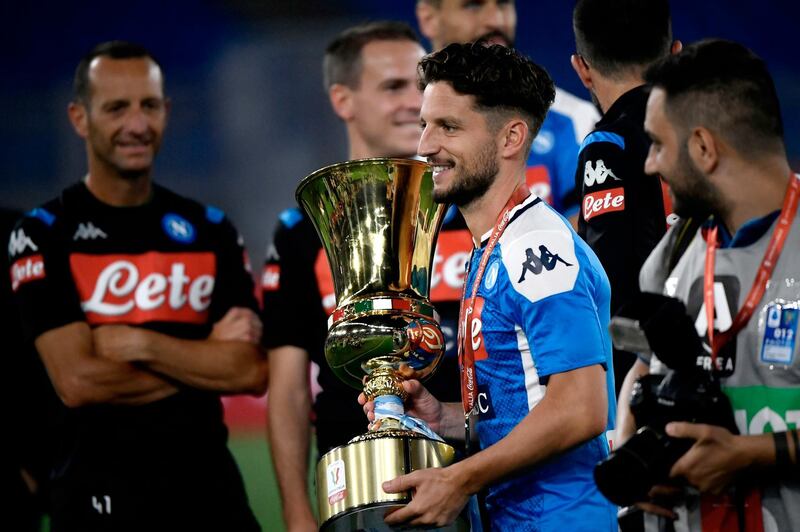 Napoli's Belgian forward Dries Mertens holds the trophy. AFP