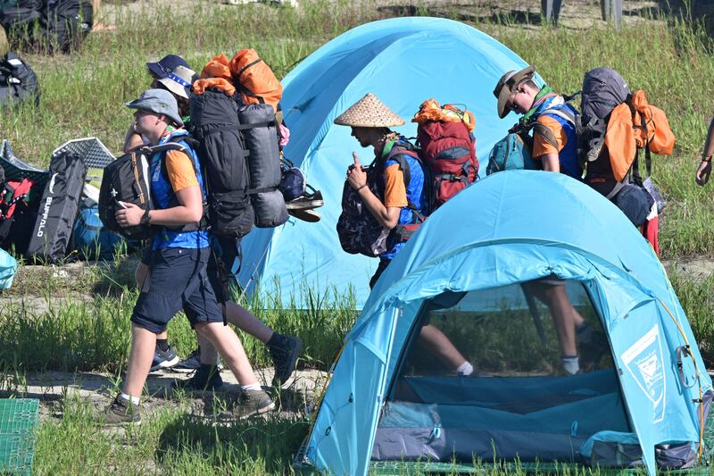 Scouts prepare to leave the campsite. AFP