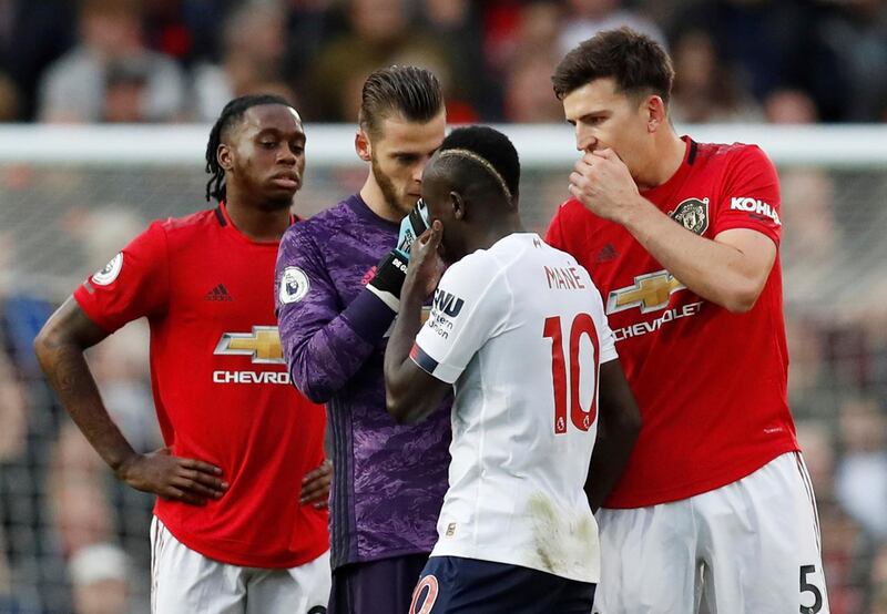 Manchester United's Harry Maguire and David de Gea remonstrate with Liverpool's Sadio Mane, who had a goal ruled out by VAR for handball. EPA