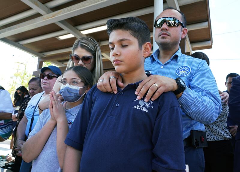 Omahar Padillo with his son Omahar Jr, 12, during a community prayer, in Pharr, Texas, for the shooting victims at Robb Elementary School. AP
