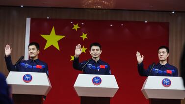 Astronauts Ye Guangfu, centre, Li Cong, right, and Li Guangsu attend a press conference in Jiuquan, Gansu province, China. EPA
