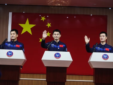 Astronauts Ye Guangfu, centre, Li Cong, right, and Li Guangsu attend a press conference in Jiuquan, Gansu province, China. EPA