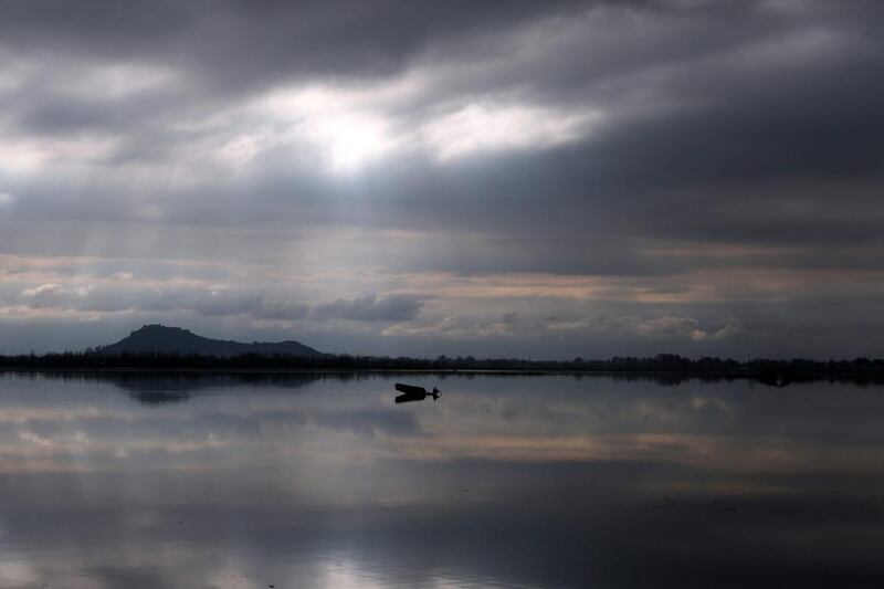 A Kashmiri man rows a boat in Dal Lake under a cloudy sky in Srinagar, the summer capital of Indian Kashmir. Farooq Khan / EPA / March 28, 2014  