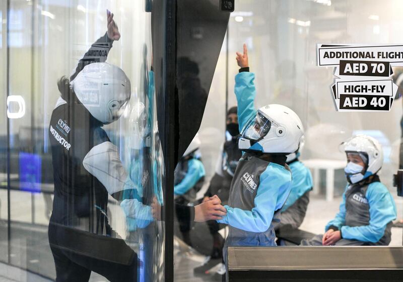 Abu Dhabi, United Arab Emirates - Mazen, 7, discussing the height limitations with the instructor before the indoor skydiving adventure at CLYMB, Yas Island. Khushnum Bhandari for The National