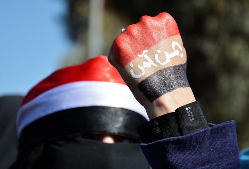 A Yemeni woman has her hand painted in the colors fo the Yemeni flag with the words reading in Arabic ‘Yemen is safe’ during an anti-Houthi protest in Sana'a. (Photo: EPA/WADIA MOHAMMED)