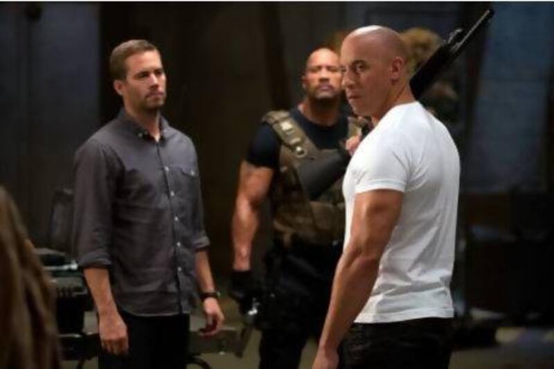 From left: Paul Walker, Dwayne The Rock Johnson and Vin Diesel in a scene from Fast And Furious 6. Courtesy Universal