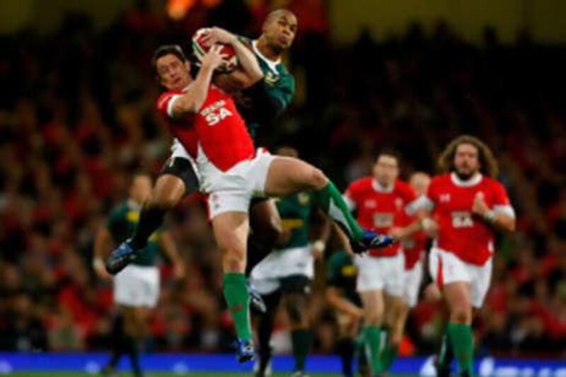 Wales' Shane Williams goes up for a high ball with JP Pietersen of South Africa during a Invesco Perpetual Series match.