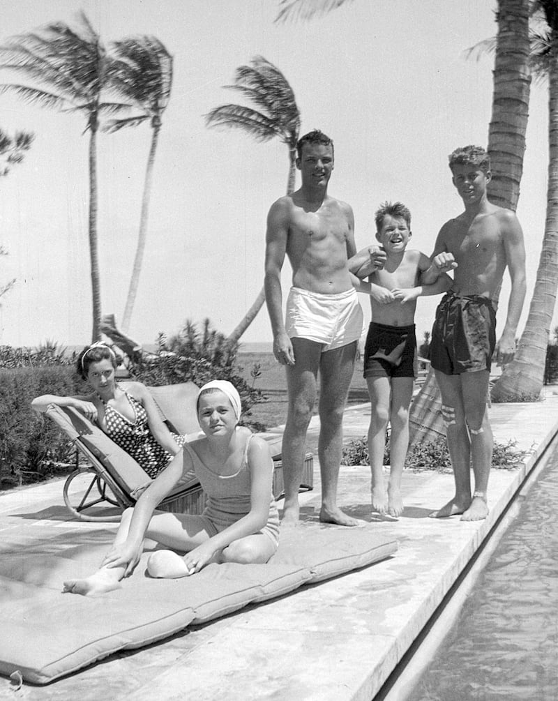 John F Kennedy, right, Robert F Kennedy, second from right, and Patricia Kennedy, front left, pose with friends in Palm Beach in 1936. AP