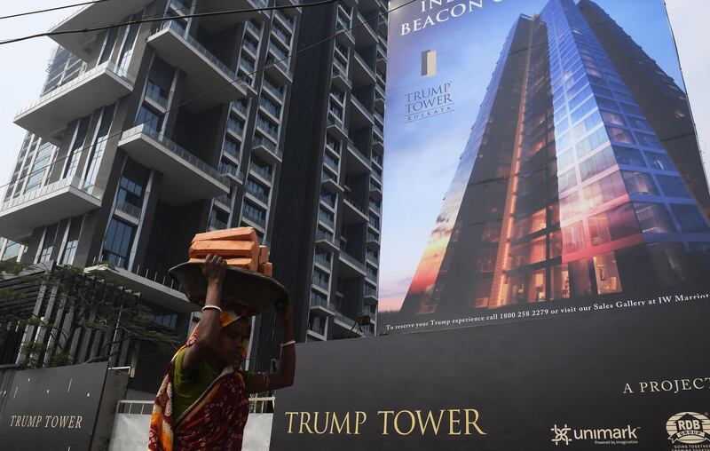 An Indian labourer works on the road leading to the under-construction Trump Tower in Kolkata. Dibyangshu Sarkar / AFP