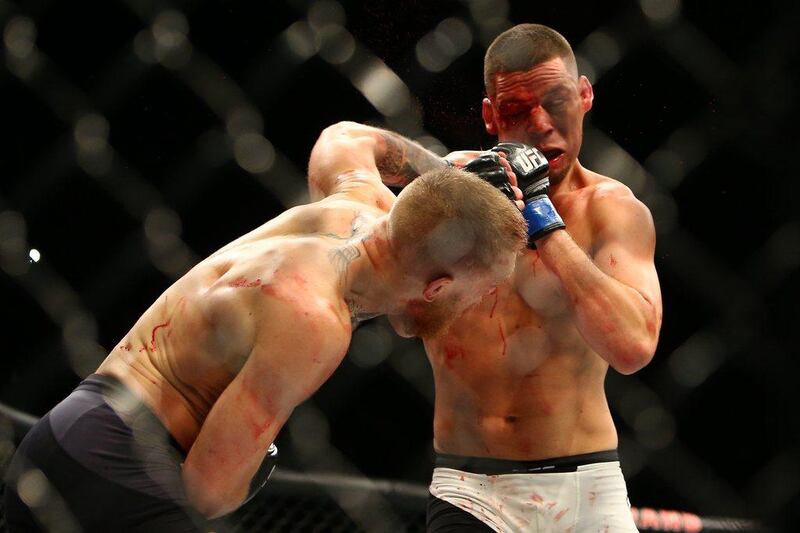 Conor McGregor punches Nate Diaz during UFC 196 at the MGM Grand Garden Arena on March 5, 2016 in Las Vegas, Nevada.   Rey Del Rio/Getty Images/AFP