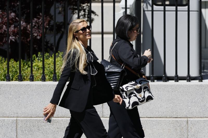 Celebrity Paris Hilton, left, walks out the Eisenhower Executive Office Building at the White House in Washington, D. C. , US, on Tuesday, May 10, 2022.  Crypto-payments company MoonPay got almost 16% of its most recent funding round from celebrities including Hilton the company said in a statement last month. Photographer: Ting Shen / Bloomberg 