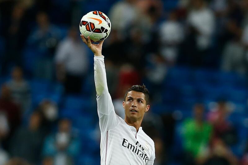 FILE - In this Sept. 23, 2014 file photo Real's Cristiano Ronaldo holds the ball as he celebrates his four goals during a Spanish La Liga soccer match between Real Madrid and Elche at the Santiago Bernabeu stadium in Madrid, Spain. (AP Photo/Andres Kudacki, files)