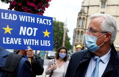 Anti-Brexit demonstrator Steve Bray holds a placard as EU's Chief Negotiator Michel Barnier walks with an entourage to a meeting in Westminster, London, Britain September 9, 2020. REUTERS/Henry Nicholls