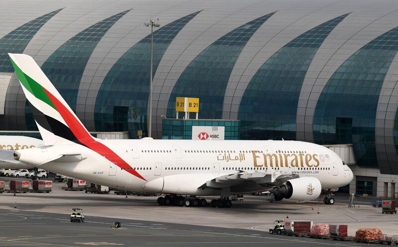 An Emirates aircraft is pictured grounded at Dubai international Airport in Dubai after Emirates suspended all passenger operations amid the COVID-19 coronavirus pandemic, on March 24, 2020 in Dubai. / AFP / KARIM SAHIB
