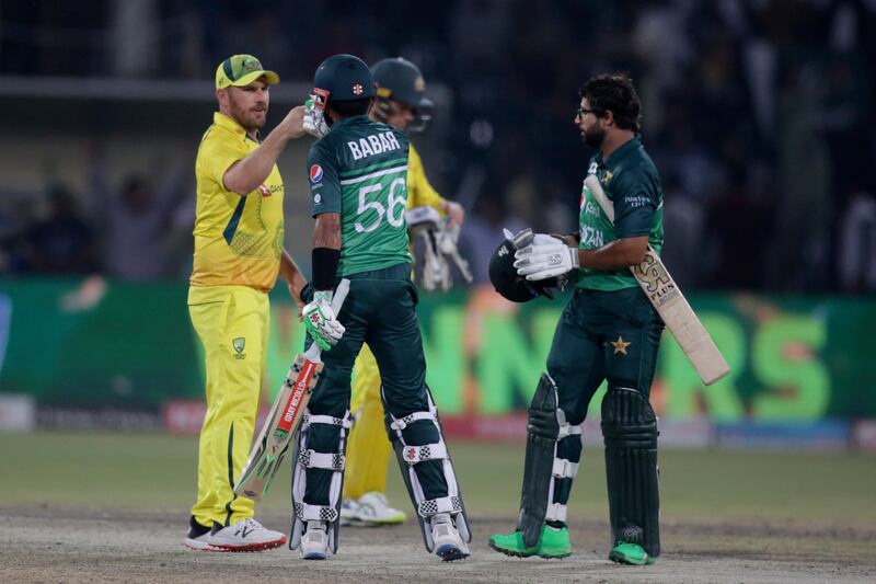 Captain Babar Azam, second left, with his Australian counterpart Aaron Finch, left, after winning the third ODI. AP