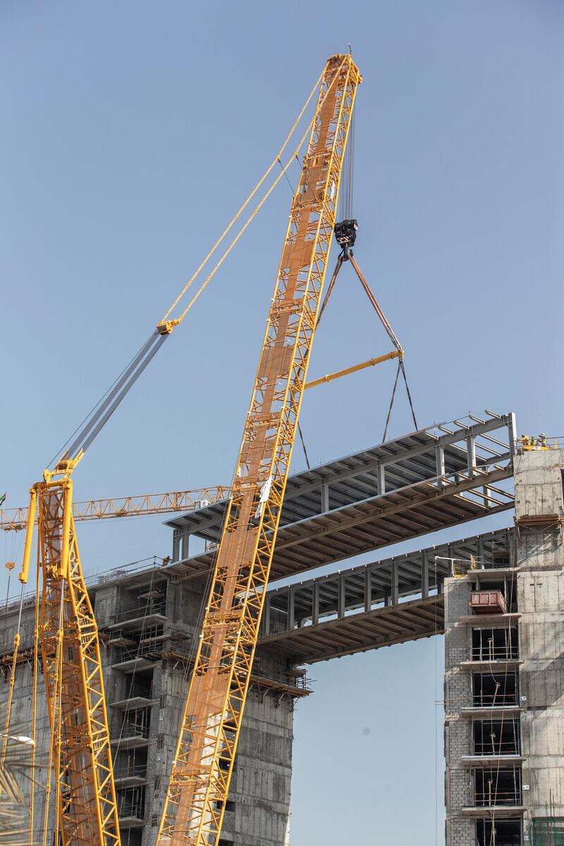 DUBAI, UNITED ARAB EMIRATES. 18 JANUARY 2021. A first for Ras Al Khaimah, an engineering marvel and a milestone in the construction of the Mövenpick Resort Al Marjan Island as a structual bridge is put in place between the hotel structures. (Photo: Antonie Robertson/The National) Journalist: Kelly Clarke. Section: National.
