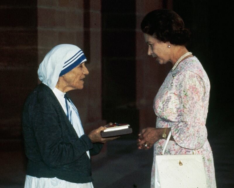Mother Teresa receives the Insignia of the Honorary Order of Merit from Queen Elizabeth in New Delhi. AP