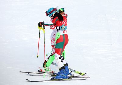 Manon Ouaiss of Team Lebanon and Ornella Oettl Reyes of Team Peru hug following the Women's Slalom Run 2 on day five of the Beijing 2022 Winter Olympic Games. Getty