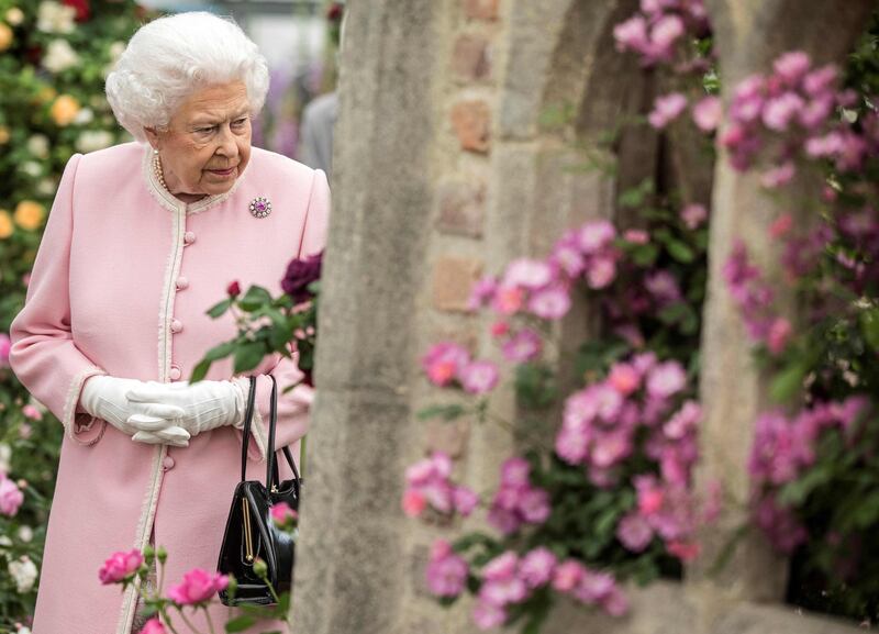 Britain's Queen Elizabeth II looks at a display of roses on the Peter Beale stand as she visits the 2018 Chelsea Flower Show in London. Richard Pohle  / AFP Photo