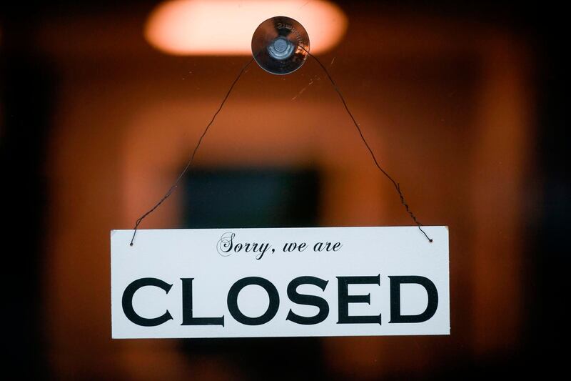 A sign reading 'Sorry, we are closed' is seen at a shop in Cologne, western Germany on January 4, 2021 amid the ongoing novel coronavirus / COVID-19 pandemic. German Chancellor Angela Merkel and state leaders are expected Tuesday, January 5, 2021 to extend a partial lockdown in Europe's top economy as coronavirus deaths continue to mount despite tough restrictions in the run-up to the holidays. / AFP / Ina FASSBENDER
