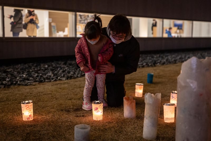 A child and her father look at a candle at the Great East Japan Earthquake and Nuclear Disaster Memorial Museum in Futaba, Japan. The magnitude-9.0 earthquake shifted the Earth on its axis by estimates of up to 25 centimetres. Getty