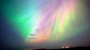 The aurora borealis, or northern lights, illuminate the sky above St Mary's Lighthouse in Whitley Bay on the north-east coast of England. PA