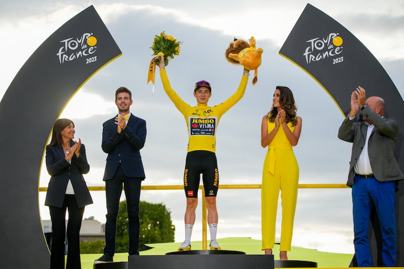 Tour de France winner Denmark's Jonas Vingegaard celebrates on the podium after the final stage. AP