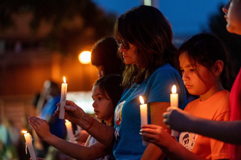 People hold candles at the vigil in Prince Albert, Saskatchewan. AP