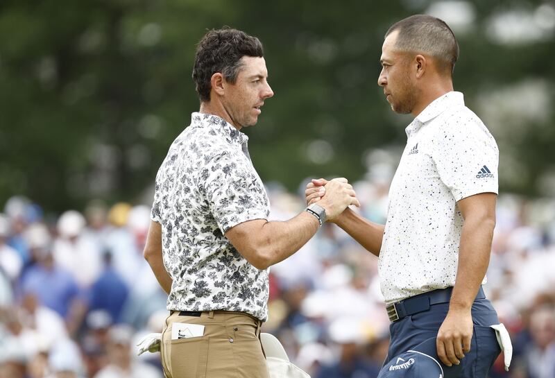 Rory McIlroy and Xander Schauffele at the ninth green during the opening round of the US Open. AFP