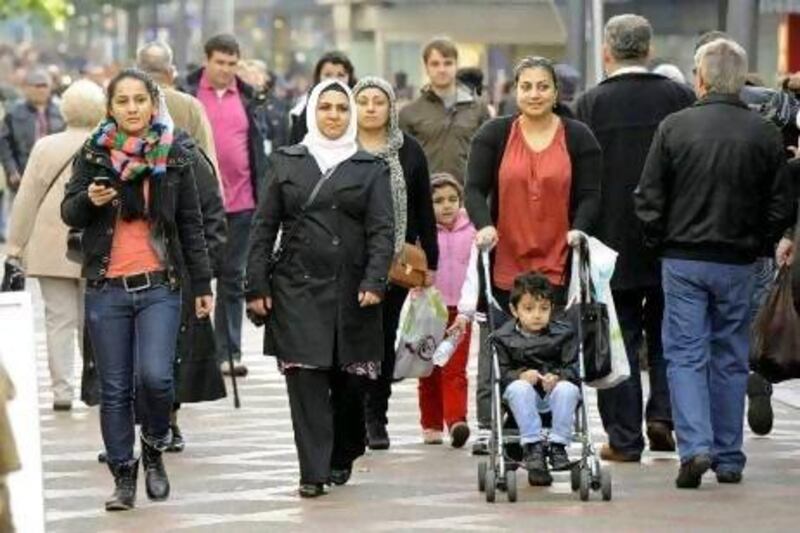 Turkish and German people walk on a shopping street in Gelsenkirchen, Germany. About 3 million of Germany’s 82.2 million people have Turkish roots.