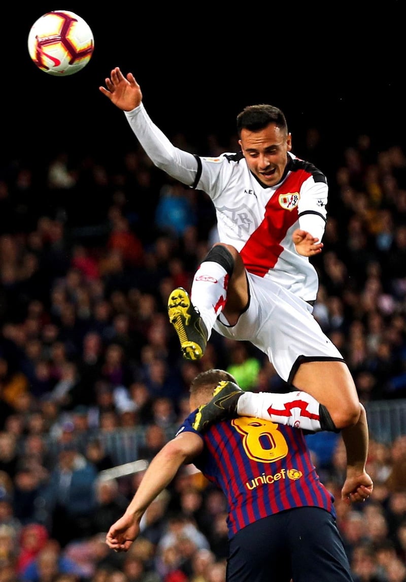 Barcelona's Arthur Melo vies for the ball with Rayo Vallecano's  Alvaro Garcia. EPA