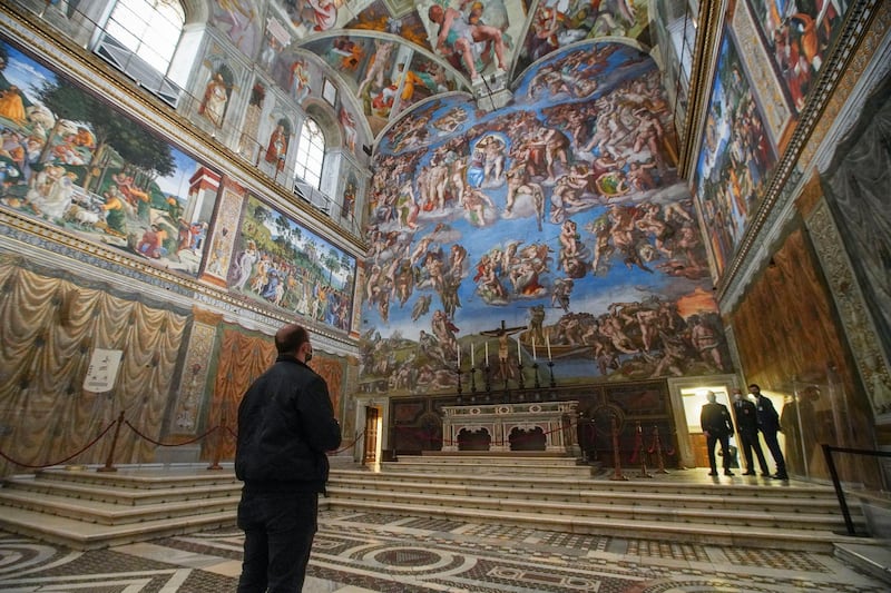 Visitors walk through the Sistine Chapel at the Vatican. AP Photo