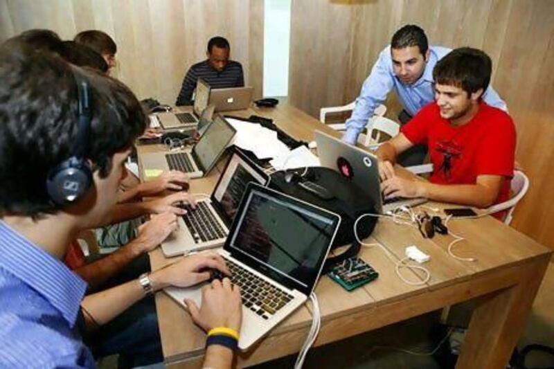 Rony El-Nashar, the SeedStartup founder, left, with Simone D'Amilo, from Metwit, right, during a mentoring session at the Pavilion Downtown Dubai. Antonie Robertson / The National